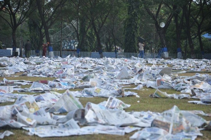 Prayer attendand left sheets of newspaper they used during Eid Al-Fitr prayer in Makassar, Indonesia on July 17, 2015.
